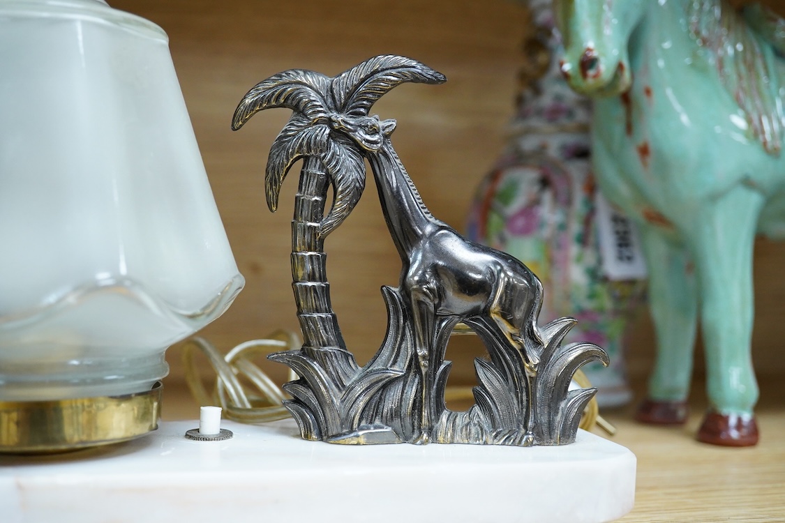 An Art Deco lamp with opaque glass shade, surmounted with a giraffe, 20cm wide